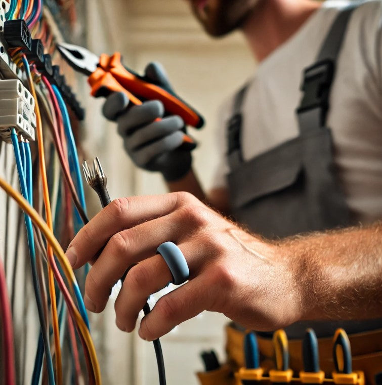 A man engaged in electrical wiring, highlighting the significance of reliable wedding bands designed for electricians.